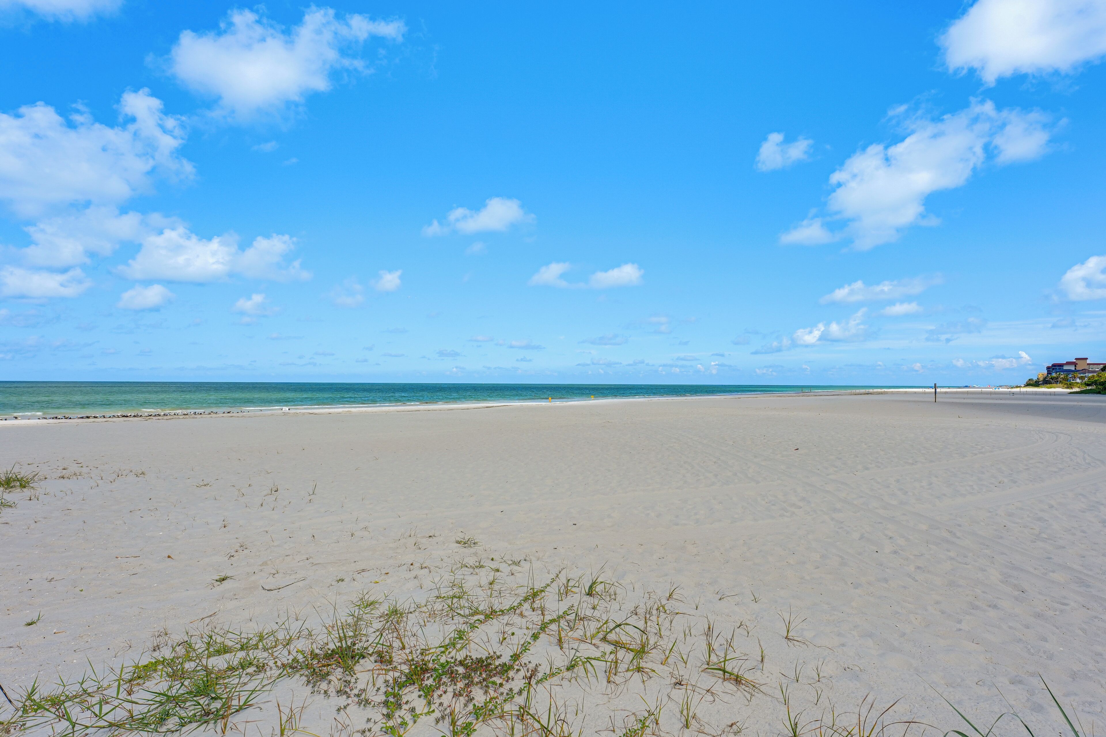 A beach with sand and a clear sky.