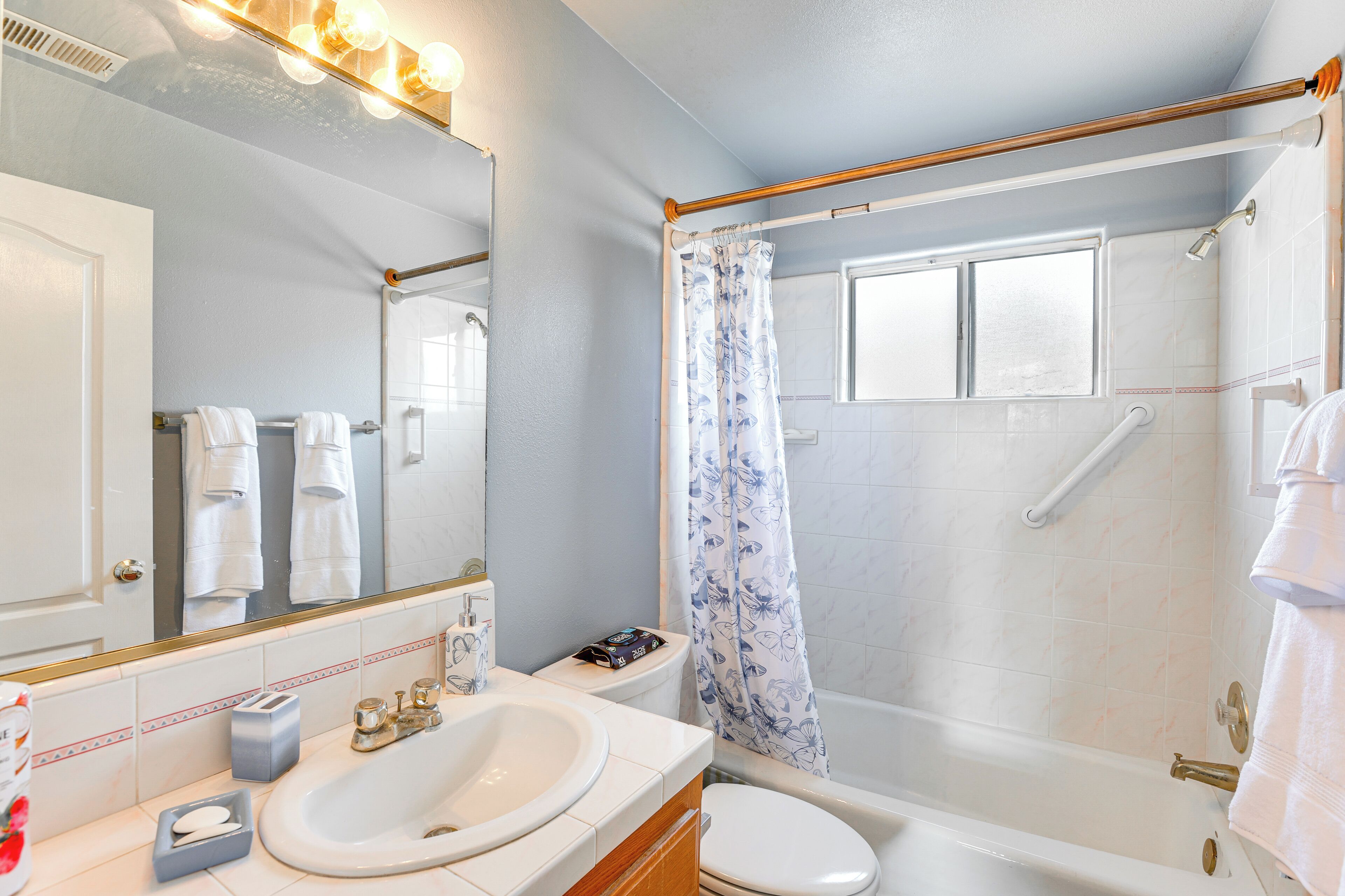 A bathroom with a sink, toilet, and shower.