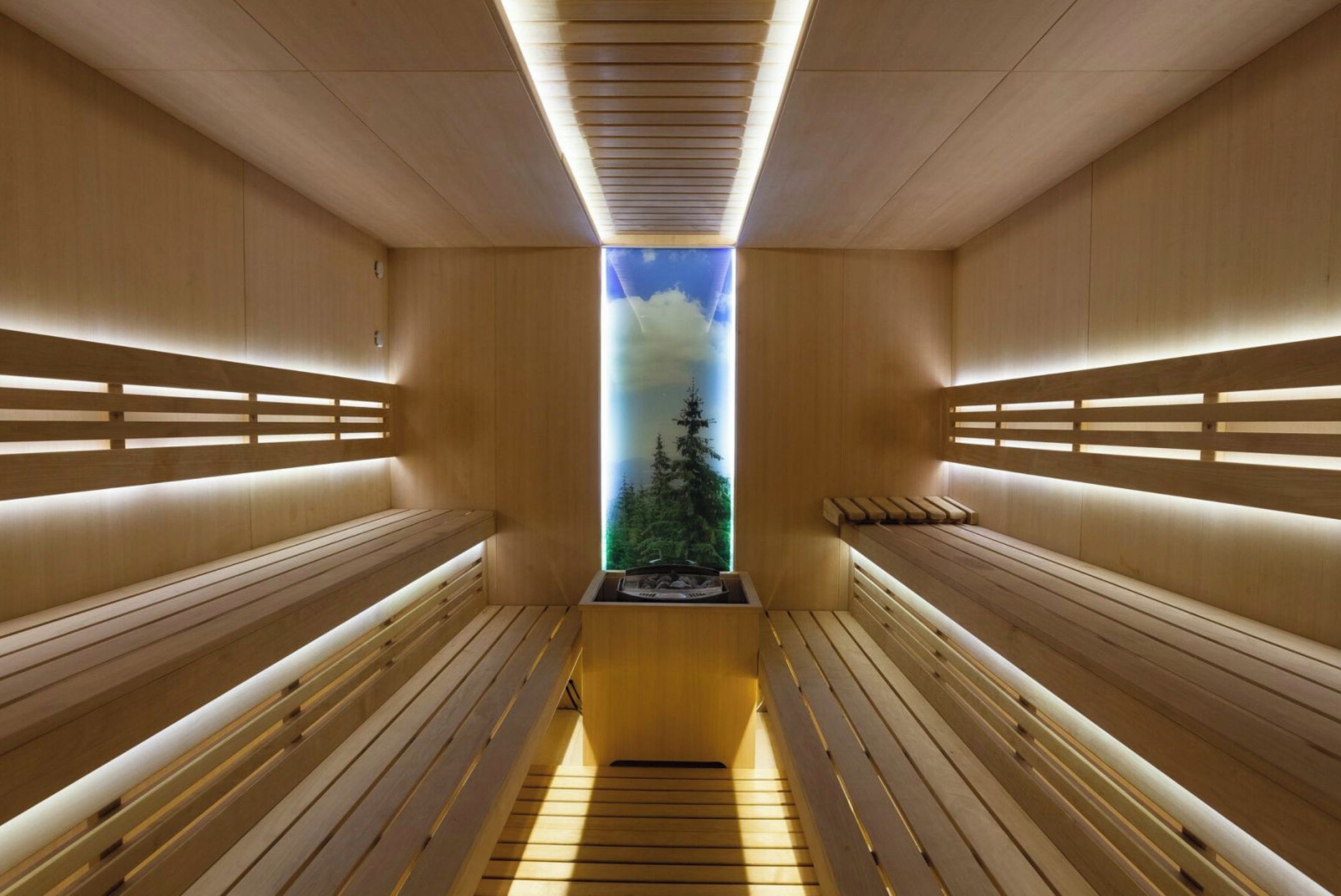 A sauna with wooden benches and a skylight.