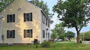 A two-story house with a gabled roof and a front porch.