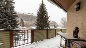 A snow-covered balcony with a view of a snowy mountain and evergreen trees. - 3-Bedroom Meadow Creek Townhom 3 Townhouse (Vail)