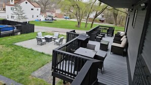 A covered outdoor patio with seating and a pool. - City Living—sleeps 12 
15-20 mins from Acrisure Stadium, PNC Park, Mt Washington (Pittsburgh)