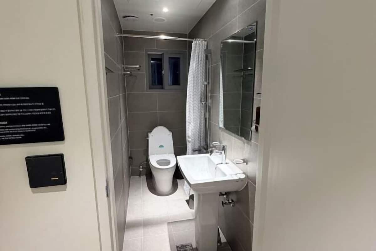 A modern bathroom with a toilet, bidet, and sink.