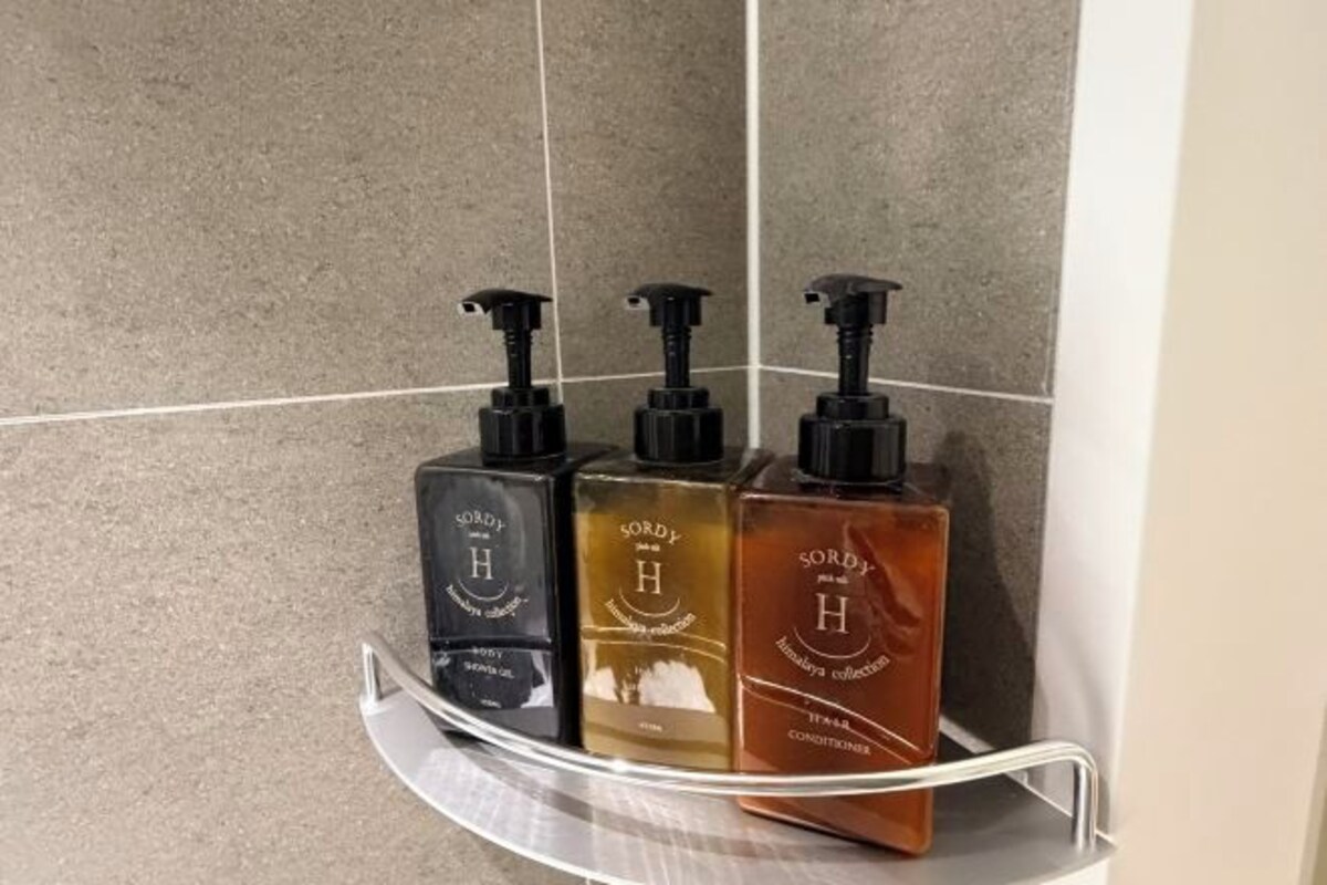 Three bottles of Sordy Handwash on a bathroom shelf.