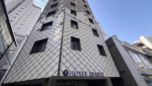 A hotel with a distinctive diamond-patterned facade and a sign reading 'HOTEL REGEN'. - Hotel Regen (Seoul)