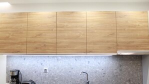 A kitchen with wooden cabinets and a granite countertop.