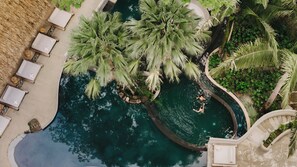An aerial view of a pool surrounded by palm trees and lounge chairs. - Esh Hotel and Spa, a Member of Design Hotels (Nosara)