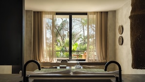 A modern bathroom with a large window, a bathtub, and a sink. - Esh Hotel and Spa, a Member of Design Hotels (Nosara)