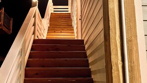 A wooden staircase with white railings leading up to a landing. - The Bay Stay has boat pier ~ 4 mi. to Beach. Cart into town- Close to Boat ramp  (Bay St. Louis)