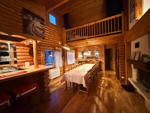 A log cabin interior with a dining area, a kitchen, and a fireplace. - Chalet Hestia (Font-Romeu-Odeillo-Via)