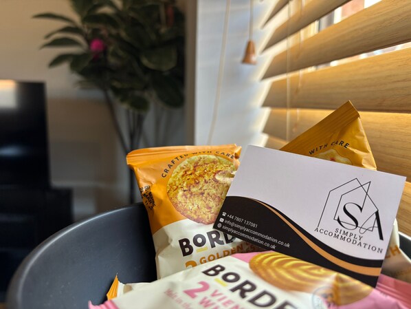 A bag of Borde cookies and a business card for Simply Accommodation.