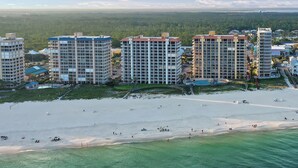 A beachfront hotel with multiple high-rise buildings, a sandy beach, and a view of the ocean. - Amazing Corner Views, Huge Balcony on the Beach! Newly Remodeled Inside and Out! (Orange Beach)