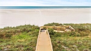 A wooden boardwalk leading to a beach with a clear sky. - Marco Island Vacation Rental, Beachfront Condo with Unobstructed Gulf Views,Pool (Marco Island)