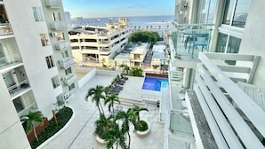 A high-rise building with a rooftop pool, multiple balconies, and a view of the sea. - Luxury Penthouse DGM Resort at Boca Chica  (Boca Chica)