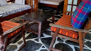 A traditional room with a bed, wooden furniture, and a tiled floor. - Sophia Baharini Diani Apartments (Diani Beach)