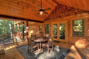 A wooden cabin with a dining area, large windows, and a ceiling fan. - Rusty Nail  | Fire Pit | Hot Tub (Mineral Bluff)