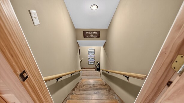 A wooden staircase with a sign at the top reading 'WELCOME TO OUR HOUSE OF THE GOODS' and 'RELAX AND ENJOY'. - Shepherd's Sky View | Secluded | MTN Views | Pool Table | (Morganton)