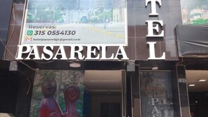 A hotel named PASARELA with a large signboard, contact information, and a view of the interior. - Hotel Pasarela Cali (Cali)