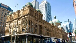 A historic building with ornate architecture, large windows, and domed structures. - KozyGuru | Sydney CBD | Charming City Studio (Haymarket)
