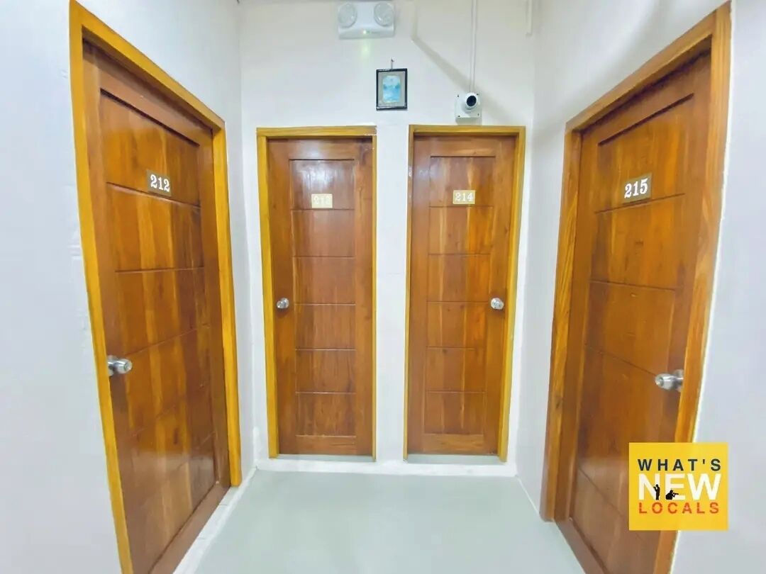A hallway with three wooden doors labeled 212, 214, and 215.