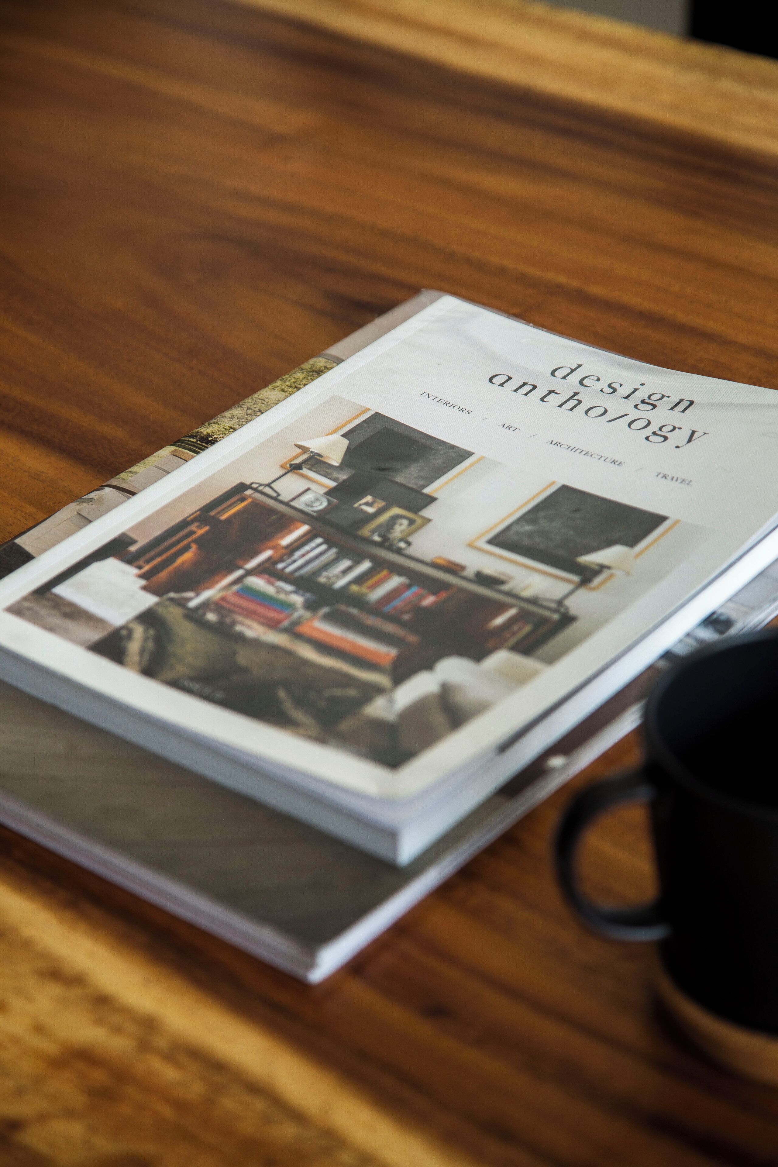 A magazine page with a book titled 'design anthology' featuring interior design images.