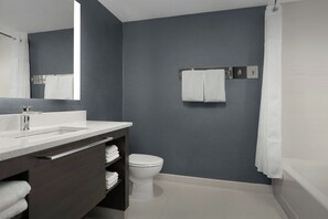 A modern bathroom with a dark gray wall, a white toilet, a white sink with a mirror, and a shower curtain. - Residence INN BY Marriott Dayton Miamisb (Miamisburg)