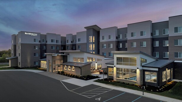 A modern hotel with multiple buildings, a parking lot, and a landscaped area with plants. - Residence INN BY Marriott Dayton Miamisb (Miamisburg)