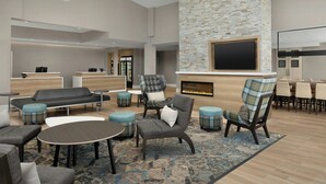 A spacious lobby with a fireplace, seating areas, and a reception desk. - Residence INN BY Marriott Dayton Miamisb (Miamisburg)