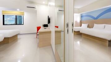A hotel room with a bed, a desk, a chair, a television, and a window with a city view.