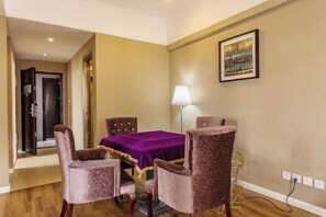 A dining area with a table, four chairs, a lamp, and a painting on the wall. - Sweetome Vacation Apartment (Galaxy) (Chongqing)