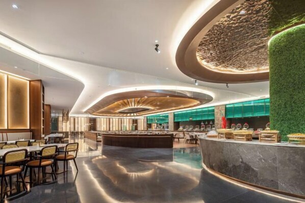 A modern hotel lobby with a central bar, seating areas, and a green vertical garden. - Changji Guesthouse (Changji)