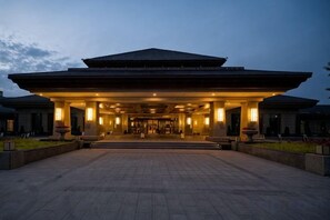 A large, traditional building with a covered entrance and a spacious courtyard. - Changji Guesthouse (Changji)