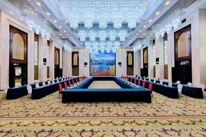 A conference room with a long table, rows of chairs, and a carpeted floor. - Changji Guesthouse (Changji)