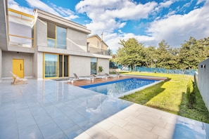 A modern two-story house with a swimming pool, a balcony, and a well-maintained lawn. - Villa Tabori Hill / Modern Retreat in Tbilisi (Tbilisi)