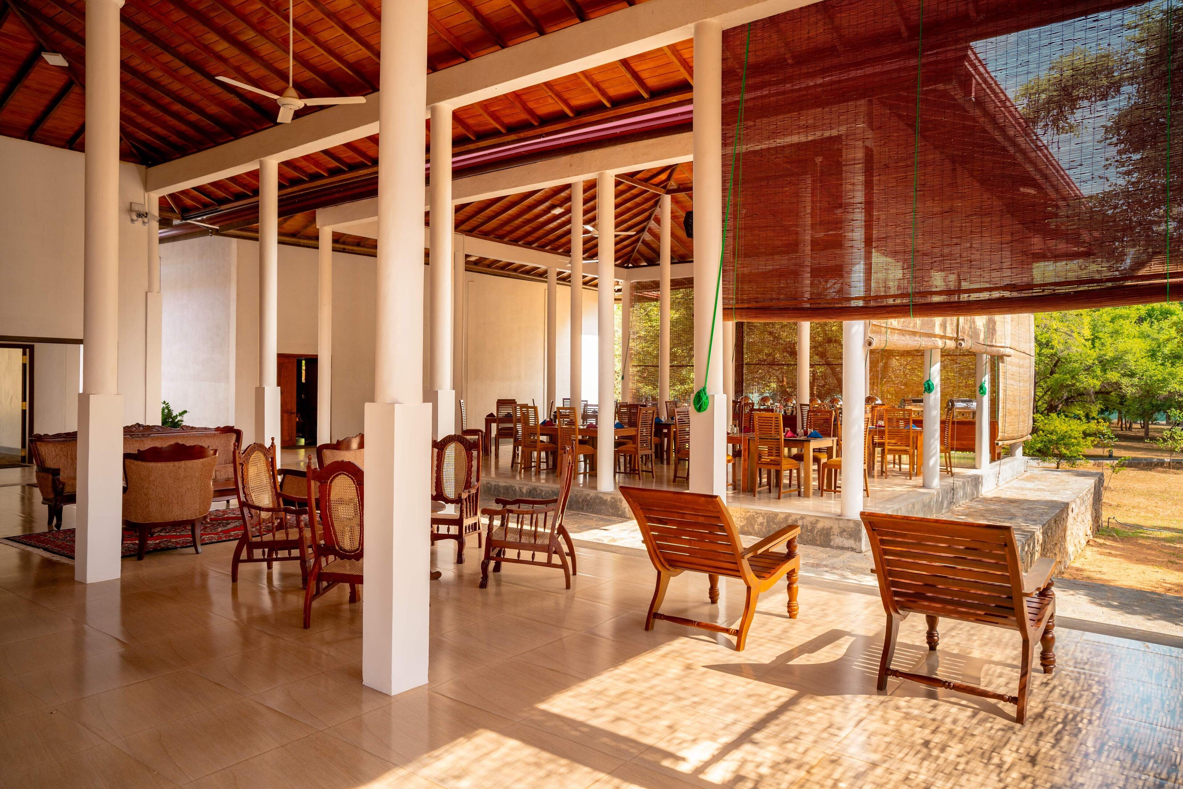 A spacious indoor area with wooden furniture and a ceiling fan.