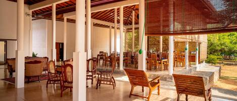 A spacious indoor area with wooden furniture and a ceiling fan.