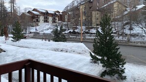 A hotel with multiple buildings, a snow-covered landscape, and a road in the foreground.