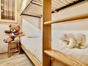 A bunk bed room with a teddy bear and a polar bear plush toy.