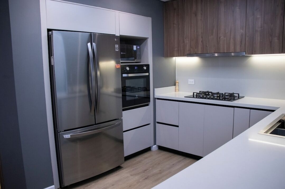 A modern kitchen with stainless steel appliances, a microwave, and a gas stove.