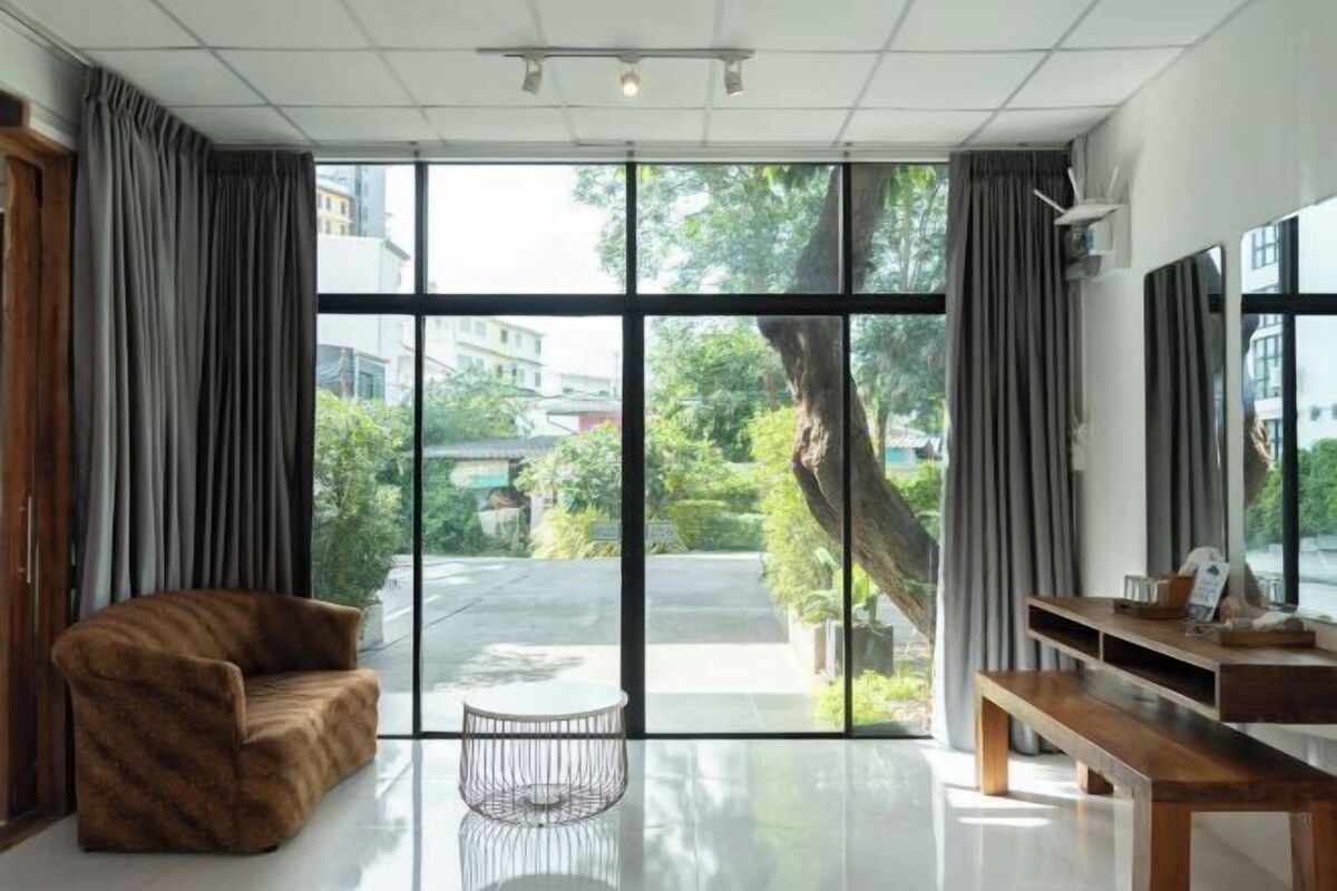 A modern living room with a sofa, a coffee table, and a TV stand.