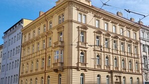 A multi-story building with a classical architectural style, featuring ornate detailing and large windows. - CORU House (Prague)