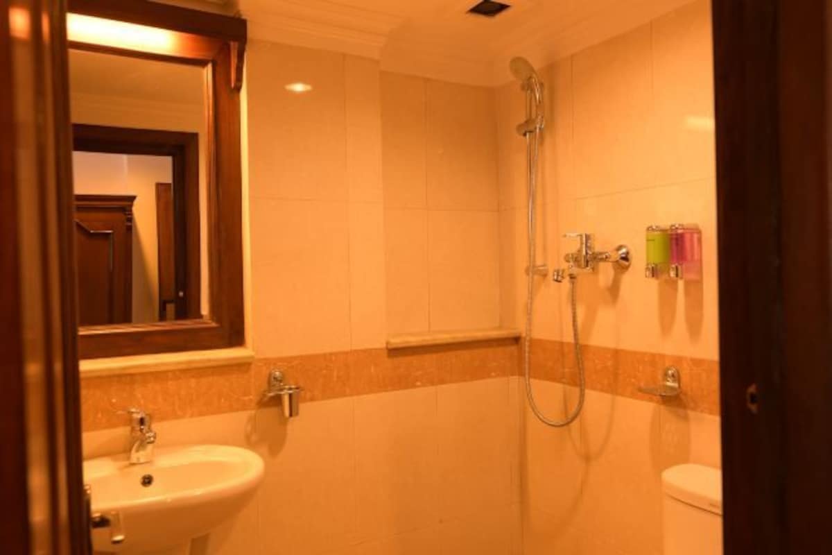 A bathroom with a sink, toilet, and shower.