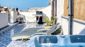 A rooftop pool area with a hot tub, outdoor furniture, and string lights. - Zisa Top Romantic terrace & private outdoor Jacuzzi (Palermo)