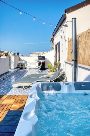 A rooftop pool area with a hot tub, outdoor furniture, and string lights. - Zisa Top Romantic terrace & private outdoor Jacuzzi (Palermo)