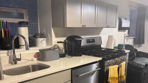 A modern kitchen with a dishwasher, stove, and sink. -  3-bedroom apt .on North Side! Great location between downtown and the airport. (Chicago)