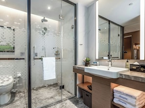 A modern bathroom with a glass-enclosed shower, a white sink, and a large mirror. - Hampton by Hilton Xining Jiaboyuan (Xining)