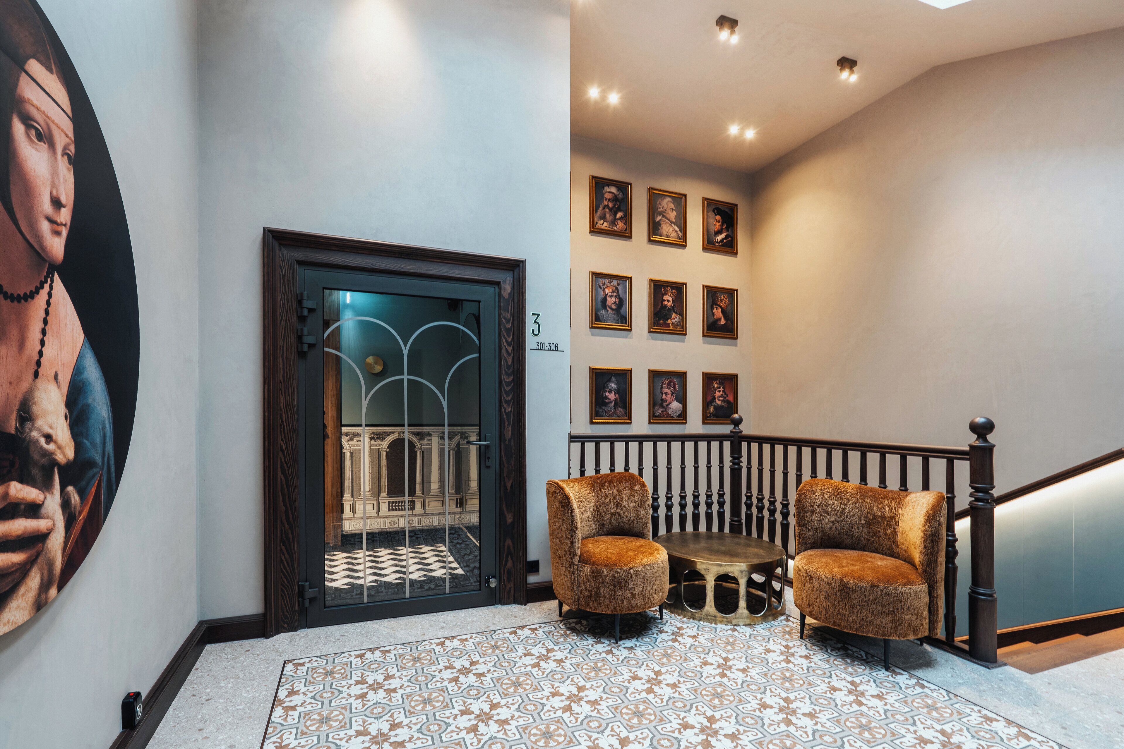 A hallway with a patterned floor, a large painting, a door with glass panels, and a staircase with a railing.