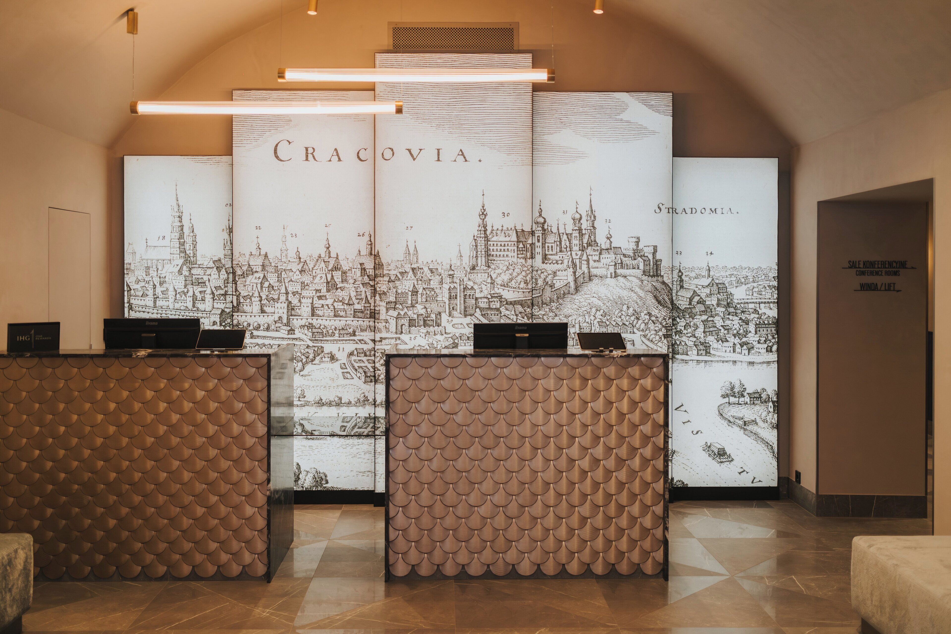 A reception area with a large cityscape illustration, a modern reception desk, and a sign for a conference room.