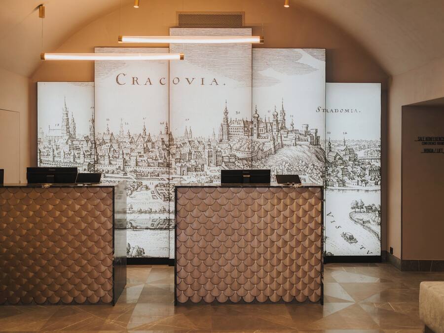A reception area with a large cityscape illustration, a modern reception desk, and a sign for a conference room.