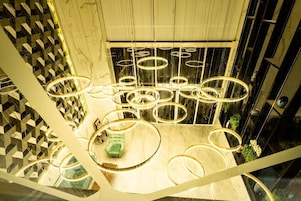 A modern interior with circular light fixtures and a geometric patterned wall.